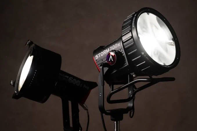 Порівняння габаритів голови моноблока Aputure STORM 700x з насадкою CF10 Fresnel та приладу лінійки LS 600 з класичною лінзою F10 на студійних стійках